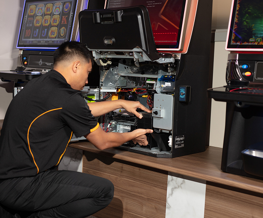 GMD technician servicing a gaming machine